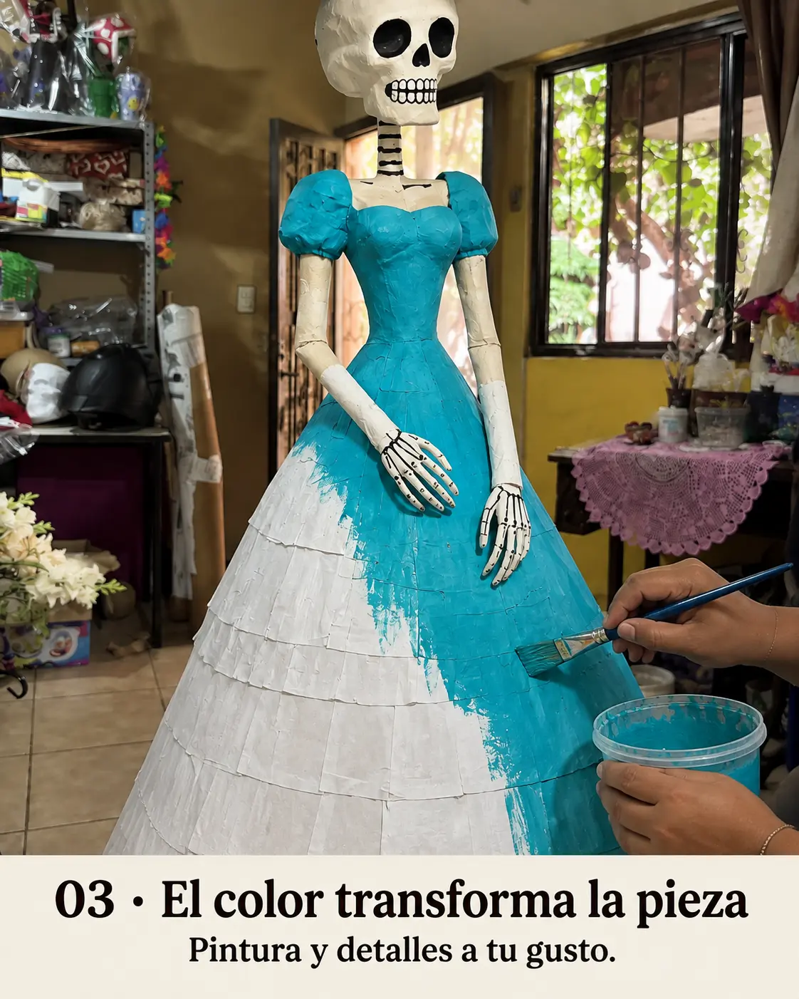 Pincel aplicando pintura turquesa sobre la catrina de papel